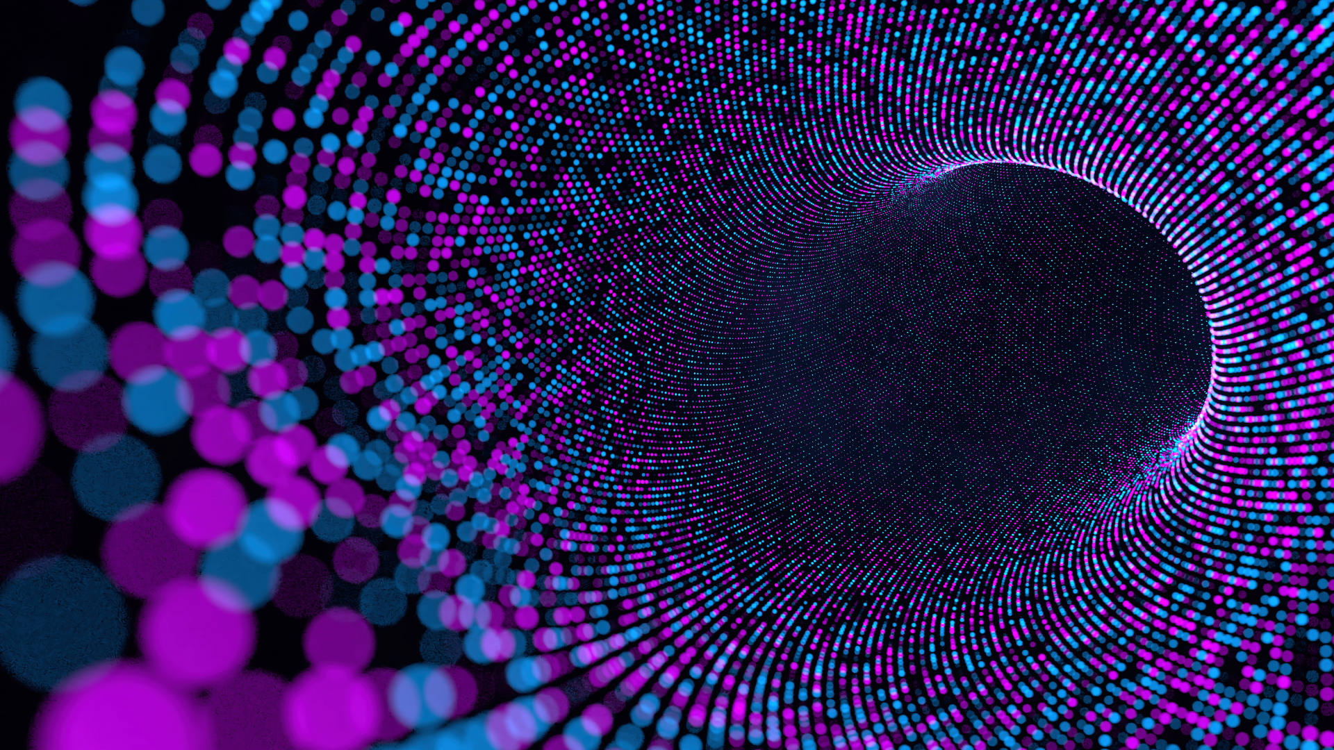 A digital illustration features vibrant pink and blue dots forming a swirling tunnel-like pattern, creating a sense of motion on a dark background.