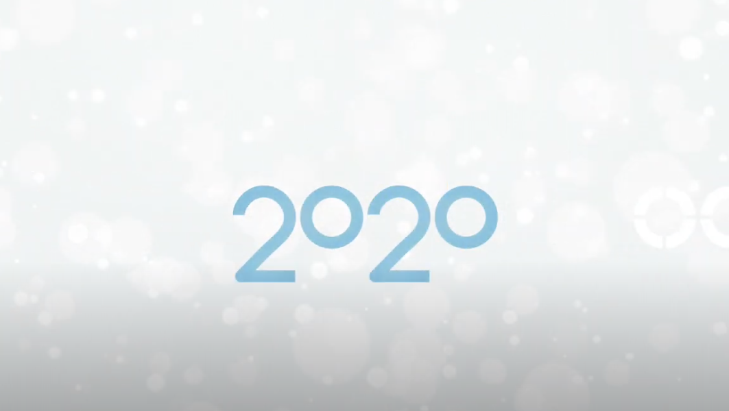The image features the number "2020" in blue font centered against a light background with faint, abstract circles and bokeh-like effects.