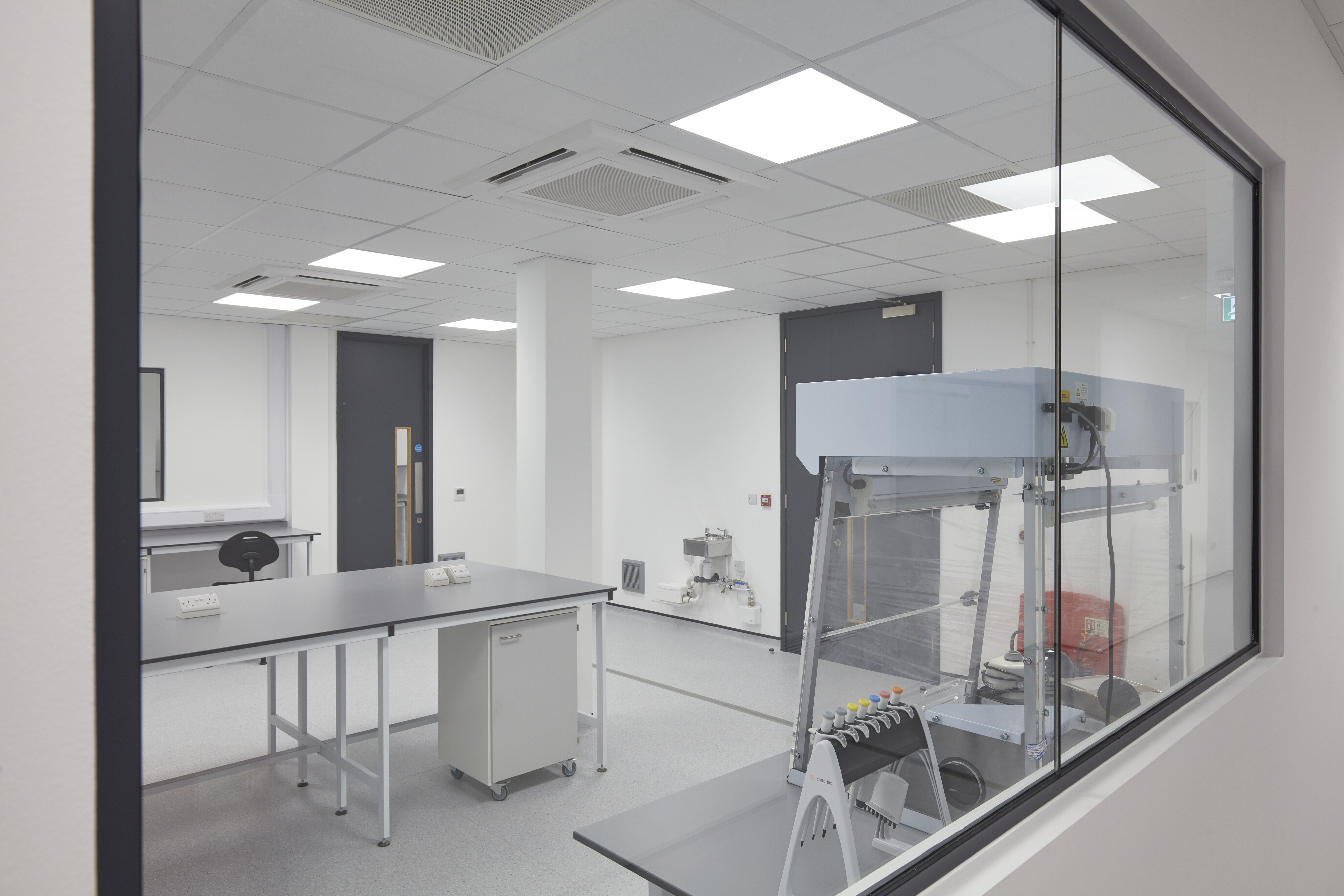 Looking through the window of an empty research laboratory which has just been fitted out.