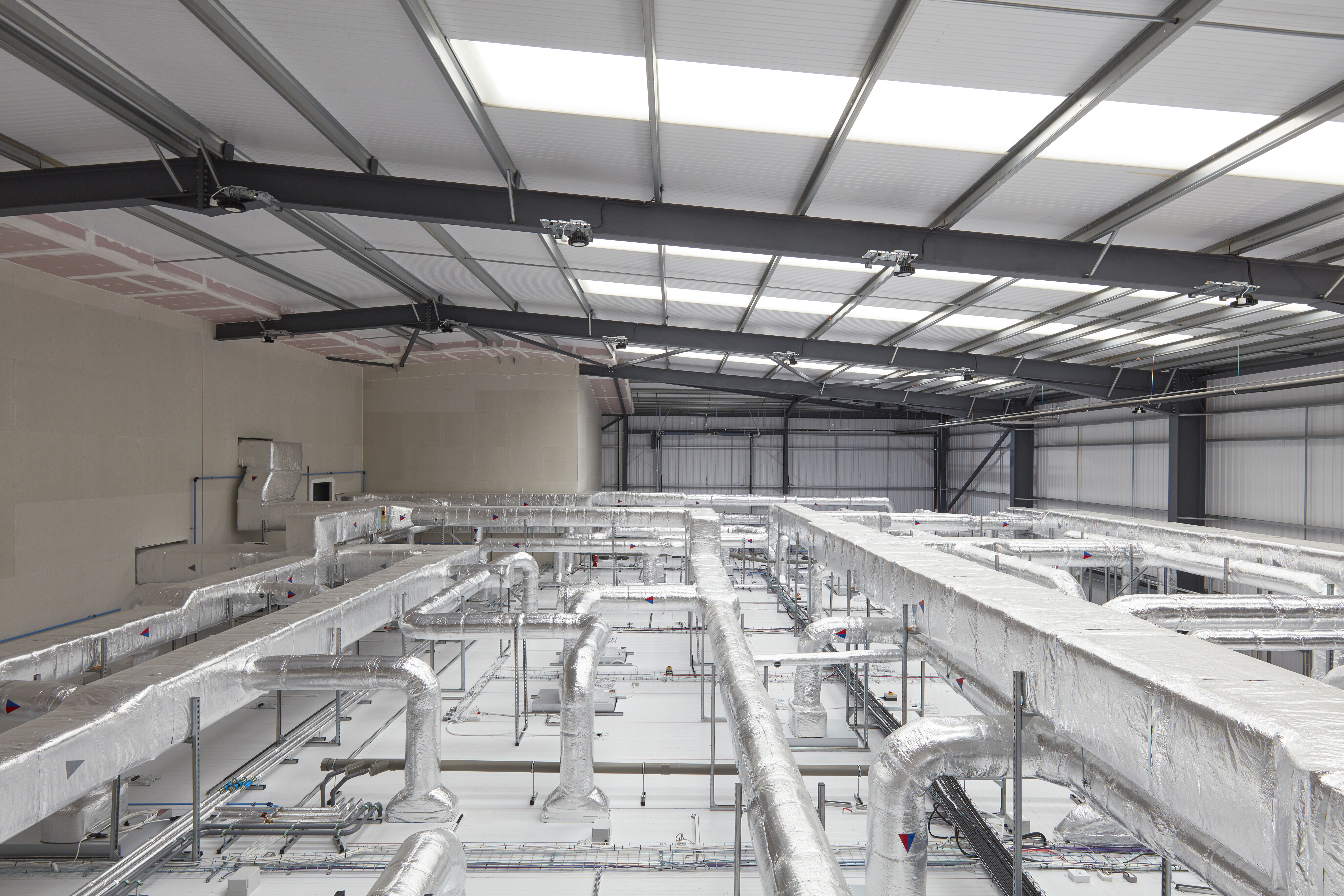 An image of pipework used for ventilating and air conditioning a lab space which has been newly converted from a warehouse