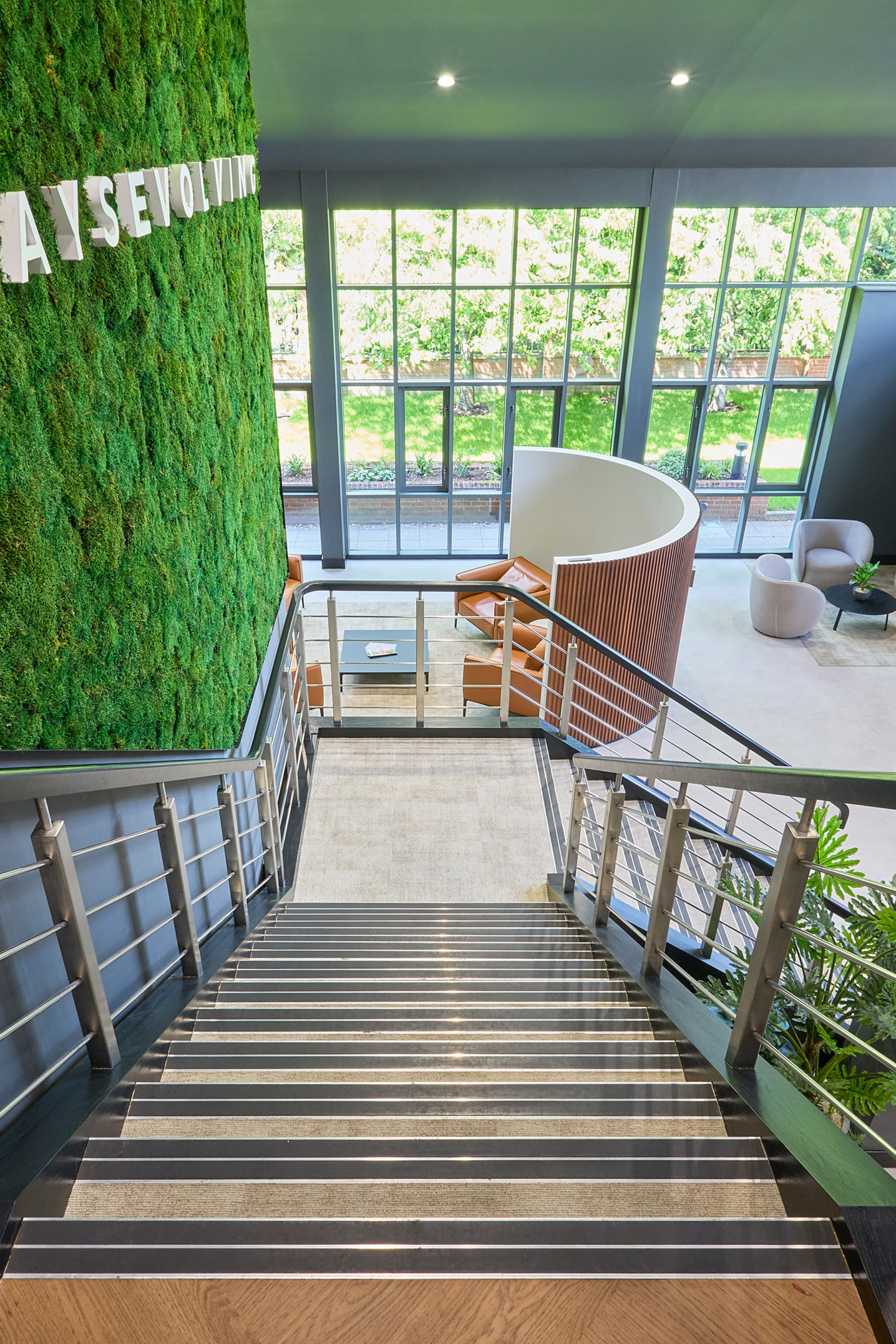 Modern interior with a staircase leading down to a lobby.