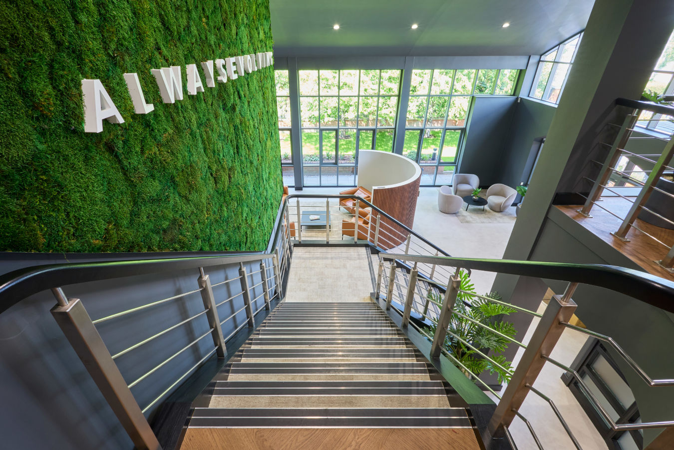 Modern interior with a staircase leading down to a lobby.